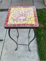 Full view of stand showing tile top and metal legs