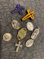 Group shot of eight pendants on textured surface