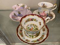 Three tea cup and saucer sets on display