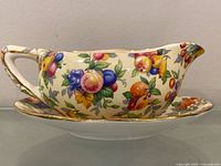 Side view of gravy boat on stand