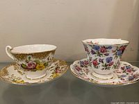 Two Royal Albert teacup and saucer sets side by side