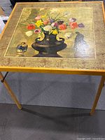 Top view showing floral still-life design and wood frame