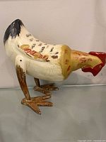 Left side of carved wood rooster figurine