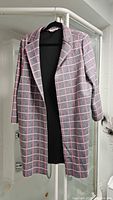 Front view of the Tanjay Glen plaid polyester jacket hanging on a rack showing the silhouette and pattern details.