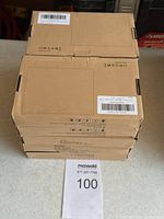 Stack of 10 kraft brown boxes containing power banks, each labeled with shipping and product codes, showing quantity in lot.