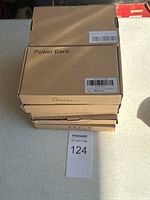Stack of 10 cardboard boxes labeled Power Bank indicating new lot packaging.