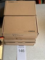 Stack of 10 boxed power banks labeled 'POWER BANK' in plain brown cardboard packaging