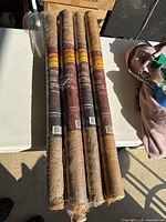 Four rolled burlap fabric with label wrapping around showing brand and product details.