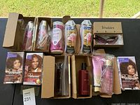 Lot overview showing all beauty products, hair dye, lotion, body wash, packaged wig or hair extensions, and sunglasses