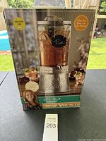 Front view of boxed Pioneer Woman Mason Jar drink dispenser with spigot, showing product image and branding.