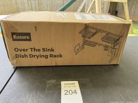 Box of Kisure Over The Sink Dish Drying Rack showing brand and model information.