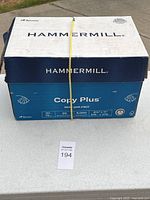 Case of 8 reams Hammermill Copy Plus with yellow strap secured around the box showing brand and packaging.