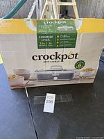 Closed box showing the packaging and product name, highlighting 3.5 quart casserole crock for 4+ people
