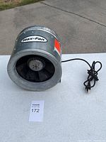 Front angle of 10-inch Max-Fan exhaust fan showing black blades inside galvanized metal casing with power cord.