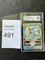 Front of the graded Alolan Vulpix VSTAR card in CGC slab showing Gem Mint 10 rating and holographic detail.