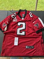 Full view of red Matt Ryan Falcons jersey with number 2 and Super Bowl LI patch.