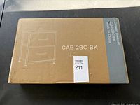 Brown cardboard box with printed image and model number CAB-2BC-BK of drawer dresser.