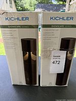 Two boxed Kichler ShowScape Series 12-Volt LED path lights in dark finish, showing packaging and product details.
