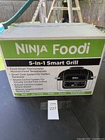 Box of Ninja Foodi 5-in-1 Smart Grill showing brand and key features.