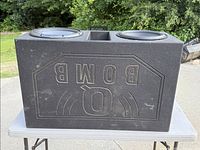 Top view showing embossed Q Bomb logo on textured enclosure