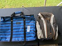 Photo showing the Scout tote bag and Columbia backpack side by side on a black surface outdoors.