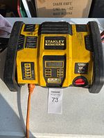 Front view of Stanley FatMax battery charger and jumper unit with power cord connected, showing overall condition and branding.