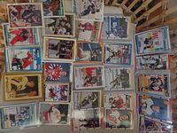 Photo of hockey cards laid out on table showing many rookie cards from 1990s including players Jagr, Brodeur, Lindros.