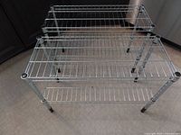 Two Ikea metal wire shelving units shown from above and front angles to display tiers and overall condition.