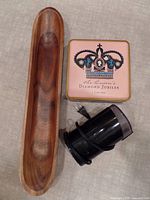 Wooden baguette holder, pink cookie tin with Diamond Jubilee crown design, and black Krups coffee grinder