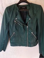 Front view of Vera Moda women's hunter green vegan leather jacket with asymmetric zipper and zippered pockets.