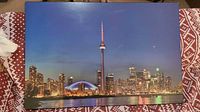 Frontal view of the large framed photograph showing the Toronto skyline at night with CN Tower