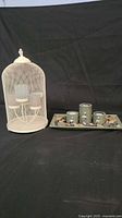 Full view of the candle holder set showing birdcage holder and pebble tray with tealight holders