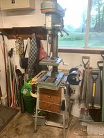 Long Chang Machinery LCN-14 drill press on metal stand with three drawers. Ryobi double wheel grinder attached at the bottom of the stand.