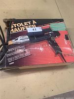 Heat tool in original packaging box showing tool image and text in multiple languages