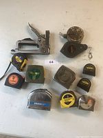 Lot overview showing all measuring tapes, stapler and chalk lines arranged on a surface.