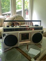 Front view of the vintage Sanyo boombox showing the speakers, cassette player and control panel.