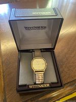 Wittnauer wristwatch in original branded box showing watch face and band.