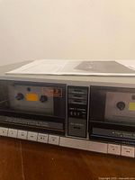 Close-up of the right cassette compartment labeled Tape 2, with tape type selections (Normal, Cr02, Metal), tape counter (520), and rec indicator.