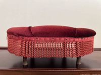 Side view showing velvet upholstery, fringe, and legs