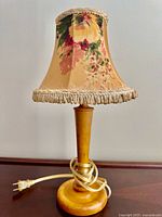 Front view of wooden lamp with floral shade