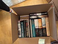 Open box showing all 30 hardcover books with six Ken Follett spines visible in front row