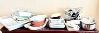 Panoramic view of all ceramic bake dishes, glass bakeware, utensils and bowls on shelf