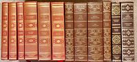 Row of brown faux-leather ICL volumes with gilt decoration showing titles including Roots, War and Peace, Anna Karenina and The Three Musketeers