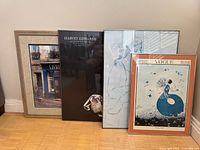 Group shot of all four framed posters standing on floor