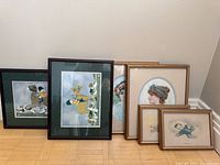 All six framed prints standing together