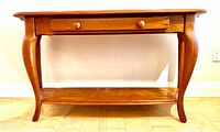Front view of pine sideboard table showing drawer, legs, lower shelf