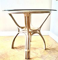 Side view of rattan table showing leg design and glass top