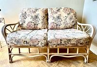 Front view of rattan loveseat showing cushions and frame