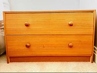 front view showing two drawers with knobs and plinth base