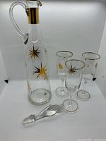 Decanter with stopper and three glasses full view